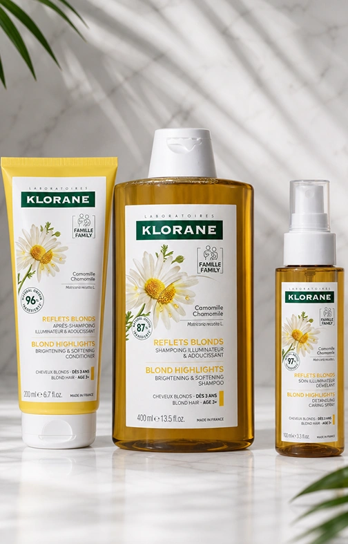 Detalle de los tres envases del set Klorane Camomila con la flor de manzanilla en la etiqueta